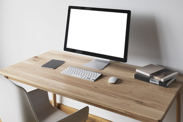 Poster - White computer screen on a wooden desk side