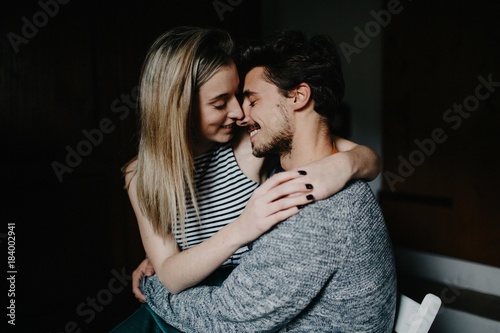 Cute Couple Snuggling At Home In Their Bedroom Kaufen Sie