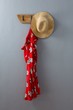 Red dress and hat hanging on hook