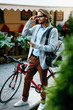 © puhhha - Man With Bicycle Using Phone On Street.