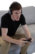 © WavebreakMediaMicro - Man playing video game against white background