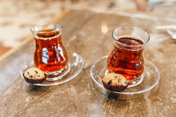 Two turkish tea in traditional glasses on cafe table