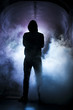 © Viktorie - Silhouette of a man with a hood in blue light