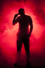 Silhouette Of A Man In Fog Red Light