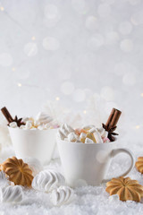 Wall Mural - A cup of hot cocoa with marshmallow or coffee with cinnamon and sweet cookies on the snow background