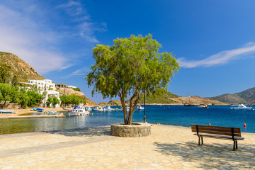 Grikos Bay with a promenade along the sea, a popular vacation spot on the Island of Patmos, Dodecanese, Greece.