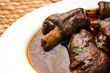 lamb shank or mutton or gosht paya or khoor curry served with indian bread or roti or naan


