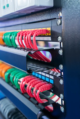 server rack with internet patch cord cables connected to patch panel in server room
