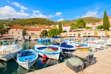 Fototapeta  - Baskets with fishing nets and boats in Bol port on Brac island, Dalmatia, Croatia