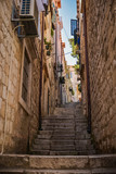 Fototapeta Przestrzenne - Narrow street with steps of medieval city Dubrovnik. Travel postcard vacation concept.