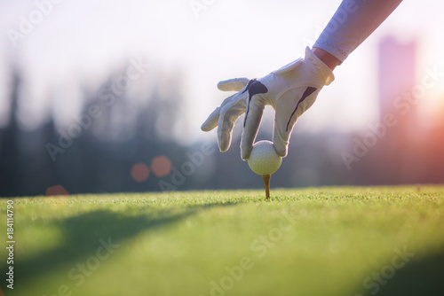 Fotografía Golf ball gentle put lie on the wooden tees by hand of woman golf player, before