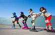 © Sergey Novikov - Kids in safety helmets rollerblading on the track