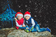 © Michael - Portrait of cute smileng boys in Santa caps looking at camera on Christmas evening in snow forest