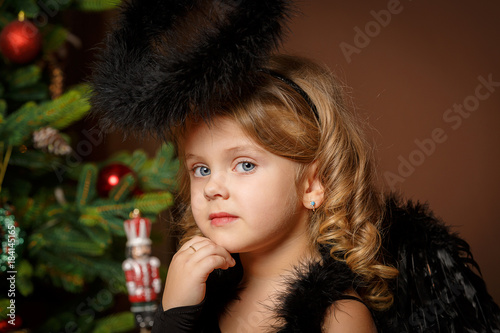 Close Up Portrait Of A Cute Little Blonde Girl With Blue Eyes In A