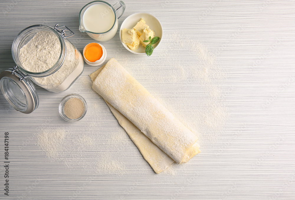 Composition with fresh raw puff dough on table