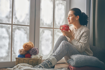 Wall Mural - woman sitting by the window