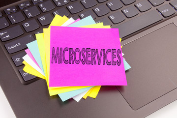 Leinwandbilder - Writing Microservices text made in the office close-up on laptop computer keyboard. Business concept for Micro Services Workshop on the black background with copy space