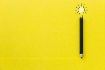 black pencil on yellow backgroud with light bulb illustration line and copyspace for inspiration and