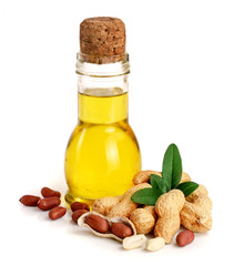 Wall Mural - peanut oil in a glass bottle with peanuts