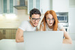 © alfa27 - Surprised Shocked couple watching something on laptop at home