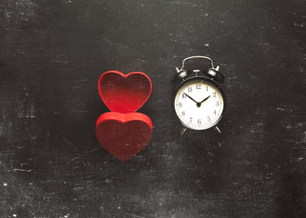 Heart shape box and black vintage alarm clock