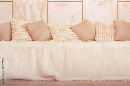 Many Pillows Lie On The Couch Which Is Covered With A Large Plush
