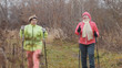 © KONSTANTIN SHISHKIN - Two elderly woman in autumn park have modern healthy training - nordic walking