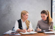 © Zoegraphy - Two young european business women are sitting on the table and discussing about their work or project