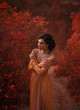 © kharchenkoirina - A fragile, tender girl in a yellow vintage dress strolls against the background of fiery autumn nature. Artistic Photography
