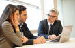 © goodluz - Young couple meeting financial advisor for home investment
