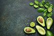Food background with green vegetables : avocado,baby spinach and lime.Top view with space for text.