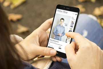 Poster - woman with fashion online shopphone in the park