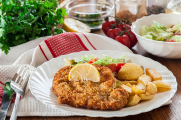 Canvas Print - Breaded viennese schnitzel with baked potatoes