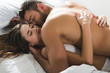 © LIGHTFIELD STUDIOS - beautiful young couple cuddling in bed in morning