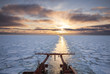 View from the aft of a research vessel crusing in ice during sunset