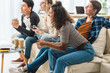 multiethnic teen girls playing video game at home