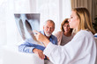 © Halfpoint - Female doctor with x-ray talking to a senior couple.