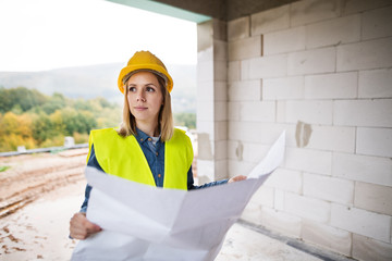 Young woman worker on the building site.