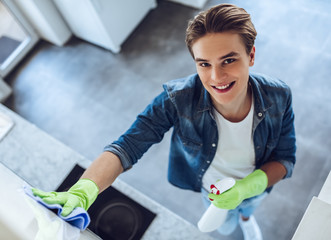 Wall Mural - Young man is doing cleaning at home