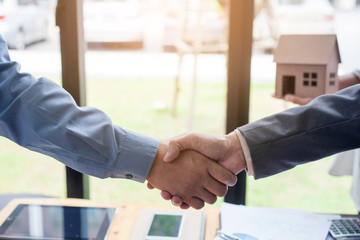 Business man shaking hands during a meeting in the office, Signing of the real estate sale agreement between buyer and broker