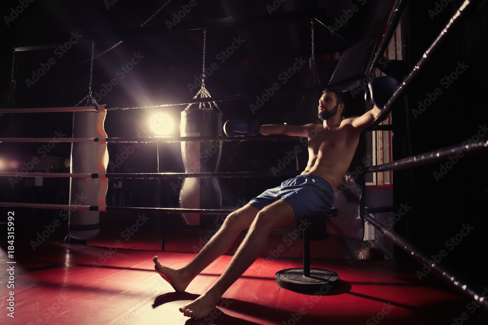 Professional boxer having break during training