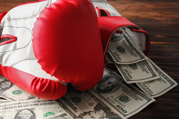 Poster - Boxing gloves and money on wooden background