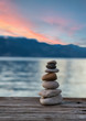 Stones pyramid on wooden pier, relaxation harmony background