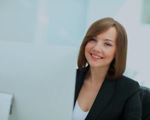 Beautiful business woman dreaming while working on computer at h