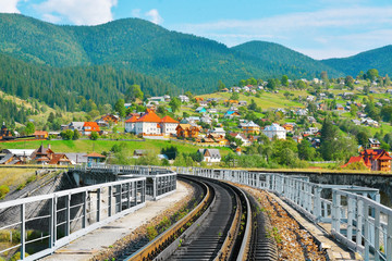 Canvas Print - Railway through village in mountains