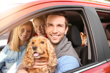 Canvas Print - Young family with dog in car