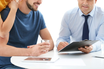 Sticker - Male insurance agent consulting young couple in office