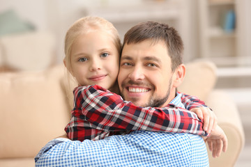 Wall Mural - Cute little girl hugging her father at home