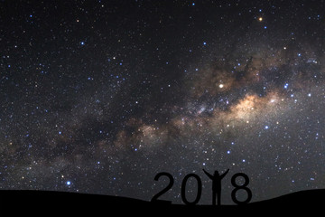 Wall Mural - silhouette of a standing sporty man for happy new year 2018 background on with milky way, night sky 