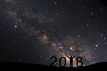 Wall Mural - silhouette of a standing sporty man for happy new year 2018 background on with milky way, night sky 